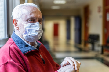 man wearing a face covering in hospital