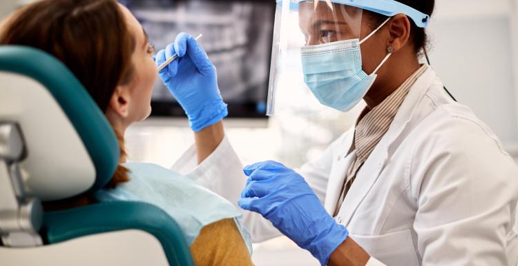 Image of a dentist performing a checkup on a patient