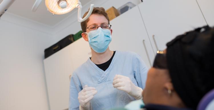 Dentist treating a patient in a treatment room