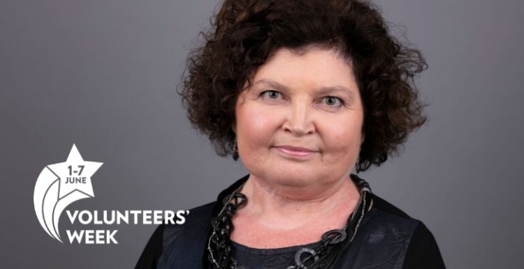 woman smiling at camera with Volunteers Week logo in corner