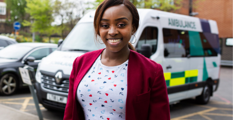 woman with an ambulance in the background