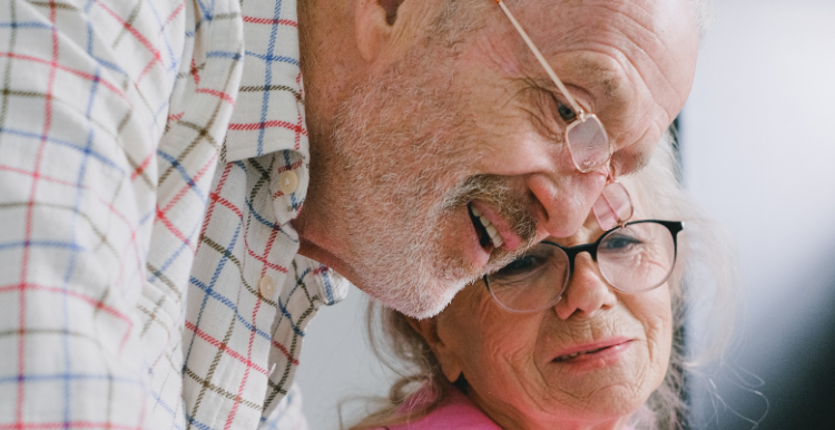 older couple sitting next to one another