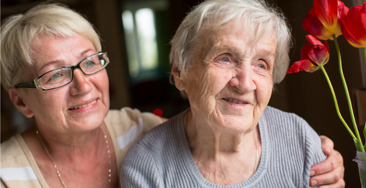 Elderly lady pictured with younger woman and some tulips