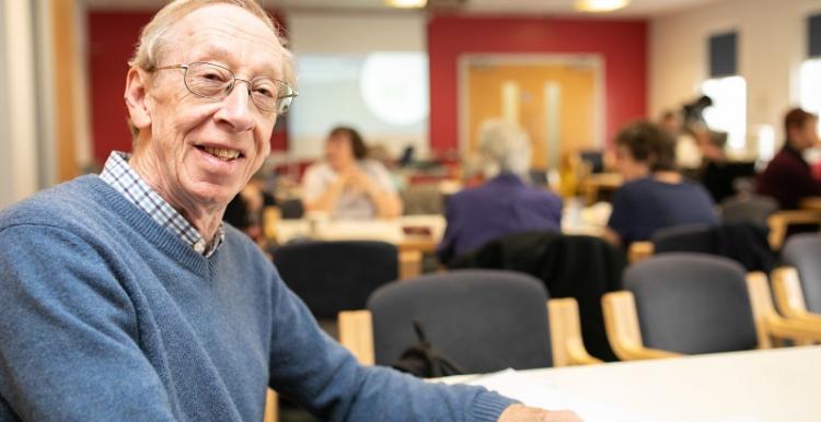 older man smiling into camera