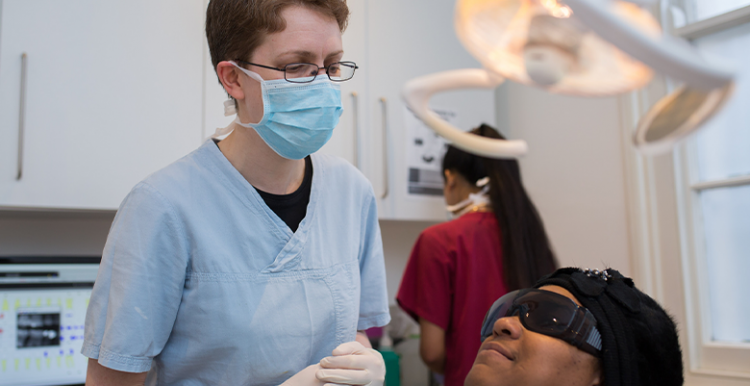 Dentist with patient in examination room