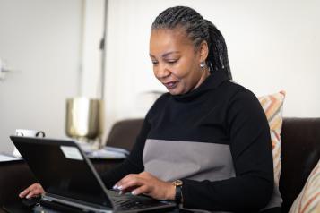 A woman typing on a laptop