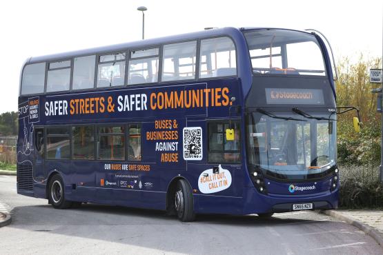 Double decker bus with Safer Streets and Safer Communities campaign message written on its side